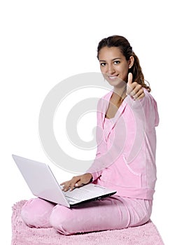 Happy woman looking backward with laptop