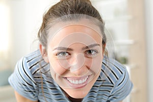 Happy woman looking at camera joking at home photo