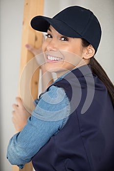 happy woman looking at camera before sawing