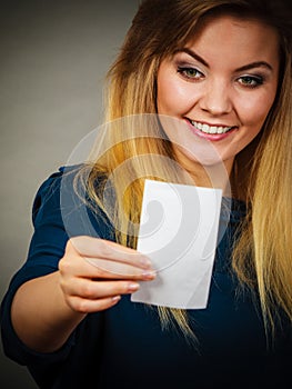 Happy woman looking at piece of papier