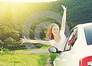 Happy woman looks out the car window on nature