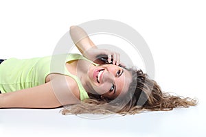 Happy woman lying down and laughing on the mobile phone