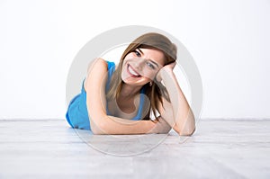 Happy woman lying on the floor