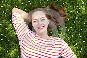 Happy woman lying in the grass