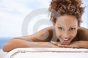 Happy Woman Lying On Massage Table