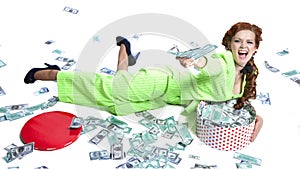 Happy woman lying with money in a box