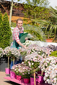 Happy woman make inventory garden shopping center