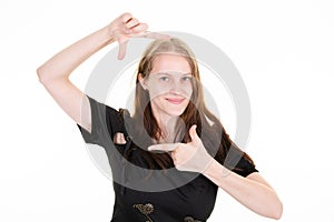 Happy woman makes frame gesture smiles isolated over white background