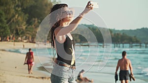 Happy woman making selfie on the beach