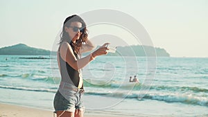 Happy woman making selfie on the beach