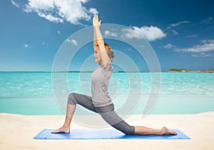 Happy woman making yoga in low lunge on mat