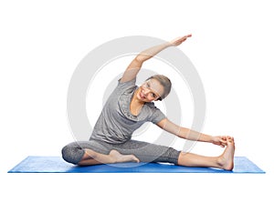 Happy woman making yoga and stretching on mat