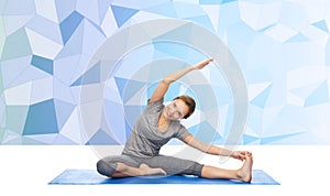 Happy woman making yoga and stretching on mat