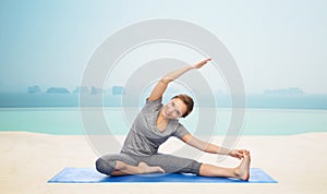 Happy woman making yoga and stretching on mat