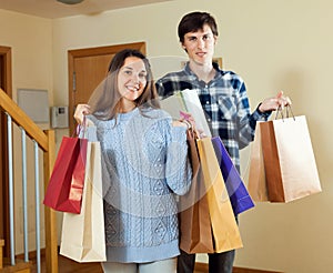 Happy woman and man together with shopping bags