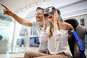 Happy woman and man with virtual reality VR glasses. Future technology fun friend concept.