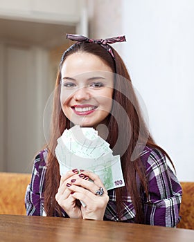 Happy woman with many euro