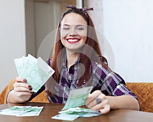 Happy woman with many euro