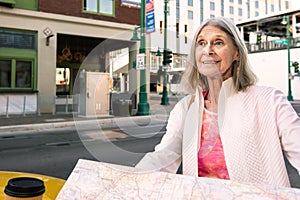 Happy Woman with Map in downtown setting