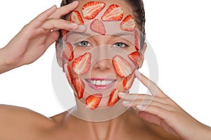 Happy woman with mask of strawberries