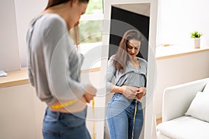 Happy Woman Measuring Waist With A Tape