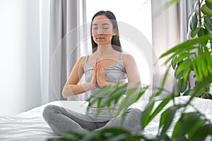 Happy woman meditating in solitude at home