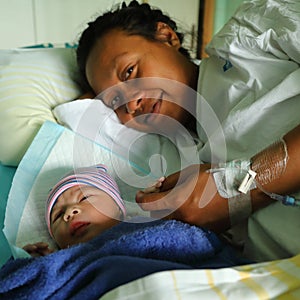 Happy woman with newborn baby