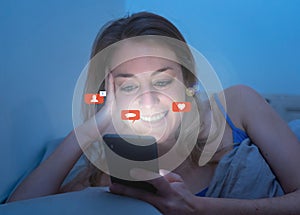 Happy woman online chatting and dating on smartphone with social media notification icons at nigh