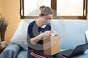 Happy woman opens her package ordered online