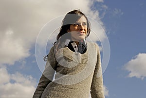 Happy woman outdoors looking at the sky with hopes