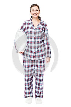 Happy woman in pajamas with a pillow in full length