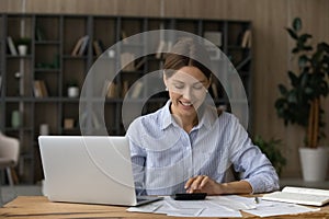 Happy woman pay bills on computer online