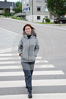 Happy woman on the pedestrian crossing