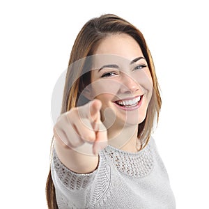 Happy woman with perfect smile pointing at camera