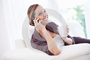 Happy woman, phone call or relax with coffee on sofa for communication, chat or mobile network at home. Lady, smartphone