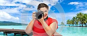 Happy woman photographer with camera on vacation