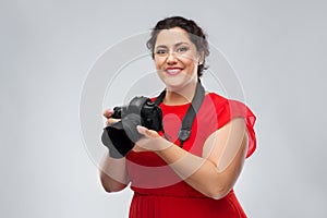 Happy woman photographer with digital camera