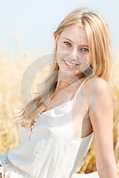 Happy woman on picnic in wheat field