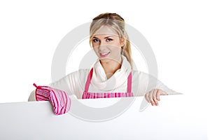 Happy woman in pink appron holding sign billboard.