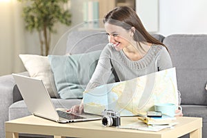 Happy woman planning vacation online at home
