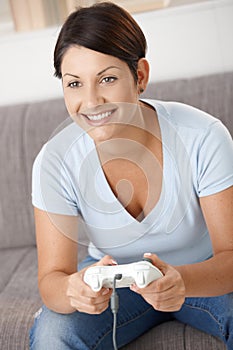 Happy woman playing video game