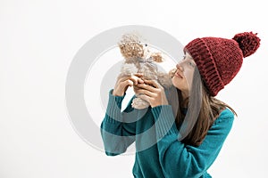 Happy woman plays with a teddy bear isolated on white