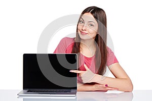 Happy woman pointing at a laptop computer screen