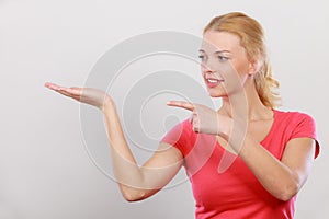 Happy woman pointing on left side