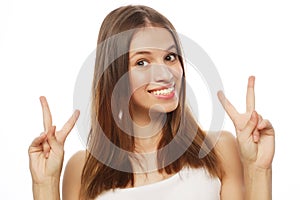 Happy woman poiting finger up at copyspace isolated on a white