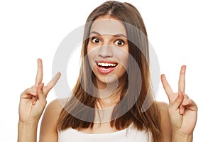 Happy woman poiting finger up at copyspace isolated on a white