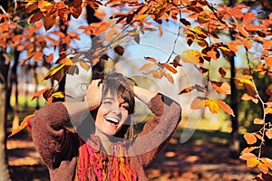 Happy woman portrait in autumn park.