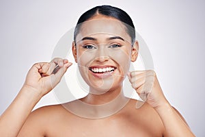 Happy woman, portrait and dental floss for clean teeth, hygiene or healthcare against a white studio background. Female