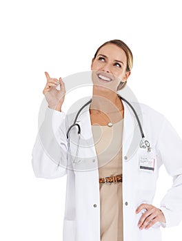 Happy woman, portrait or doctor pointing up to ideas at mockup space on white background in studio. Marketing