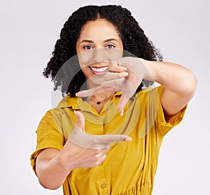 Happy woman, portrait and frame hands for photography, picture or creativity against a white studio background. Female